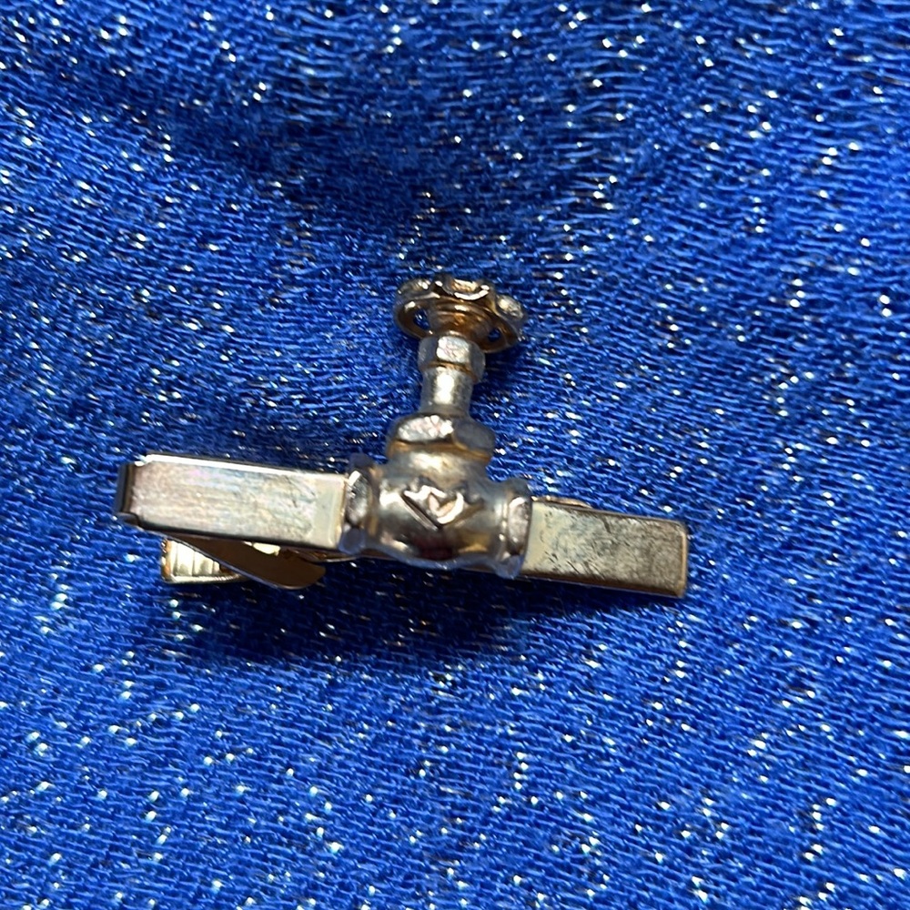 Tie clip for a plumber gold toned